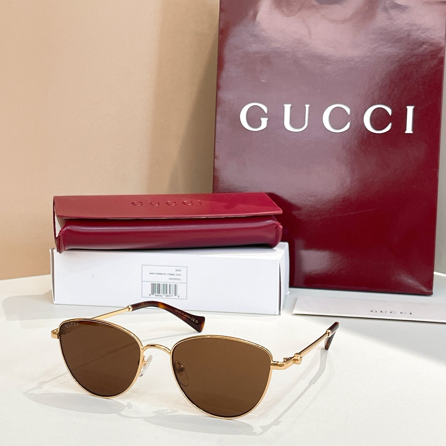 Sunglasses with gold frame and brown tinted lenses.