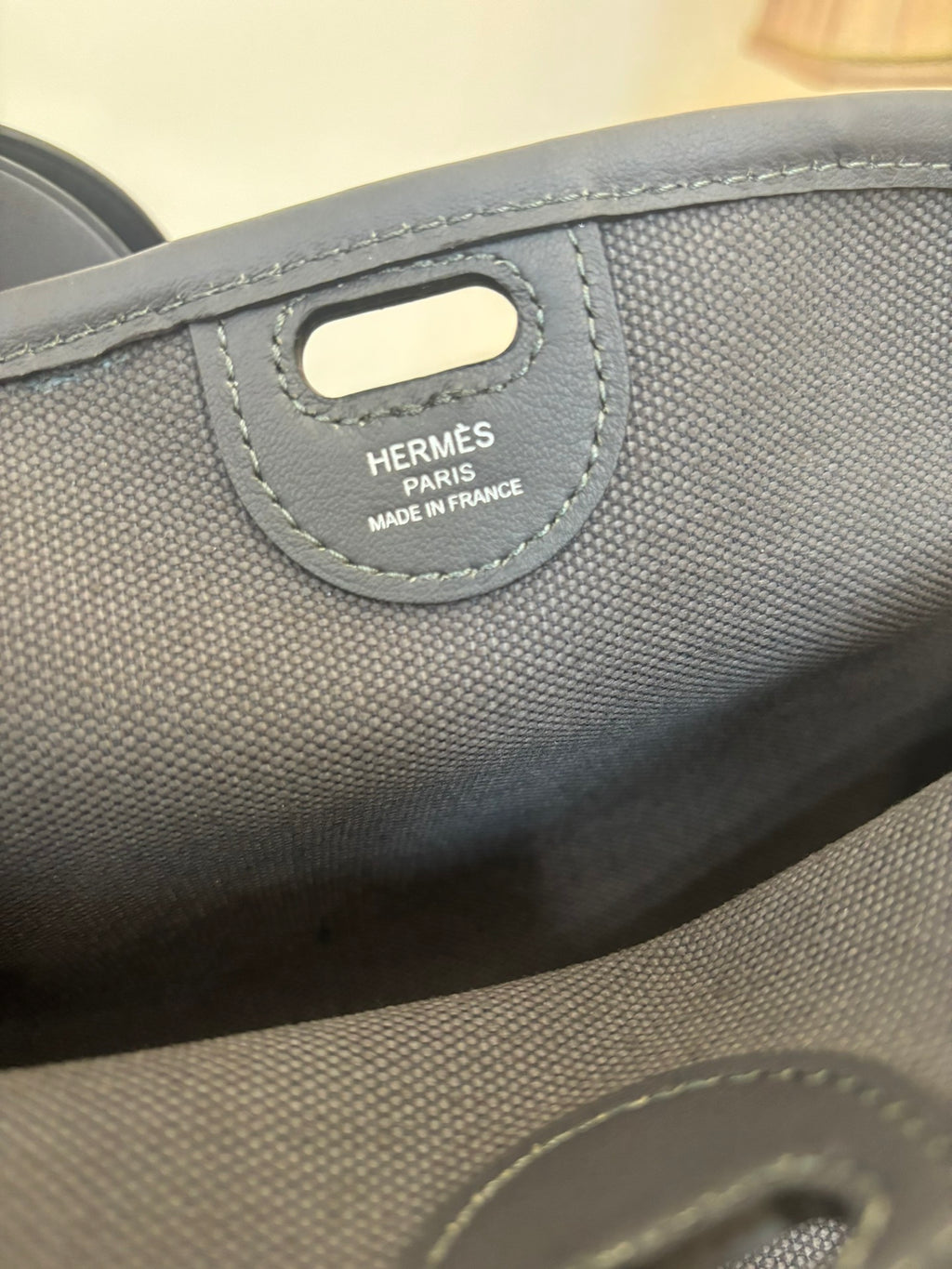 Blue textured handbag tag reading HERMÈS PARIS and MADE IN FRANCE