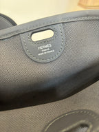 Blue textured handbag tag reading HERMÈS PARIS and MADE IN FRANCE