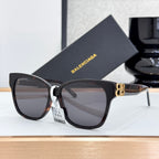 Balenciaga sunglasses with dark lenses, black frames, and gold B logo detail