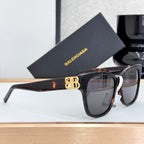Balenciaga sunglasses with dark lenses, brown tortoiseshell temple, and gold B emblem