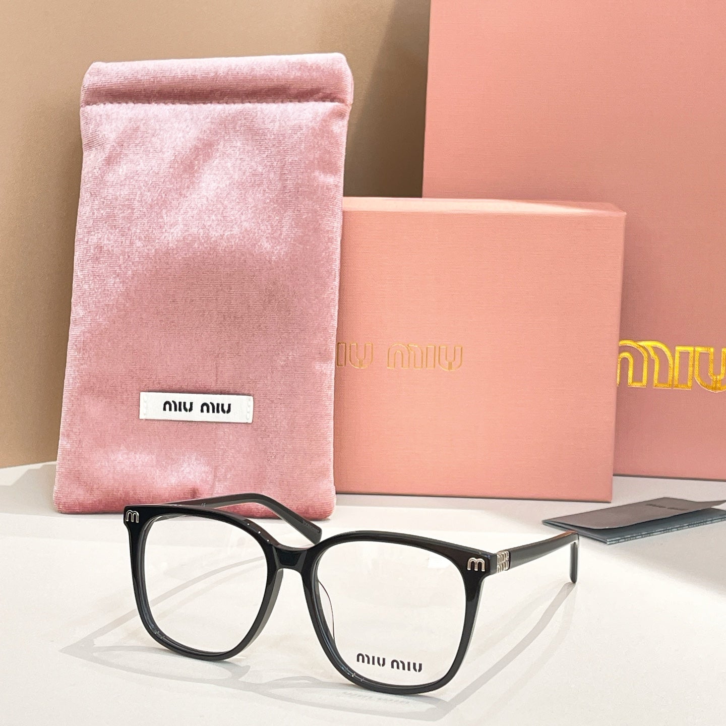 Black full-rim eyeglasses with pink velvet pouch and case