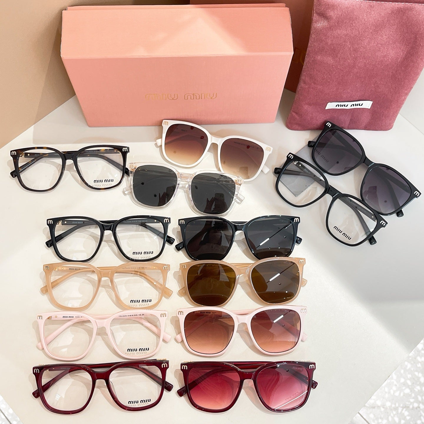Assorted sunglasses and eyeglasses with pink case and pouch