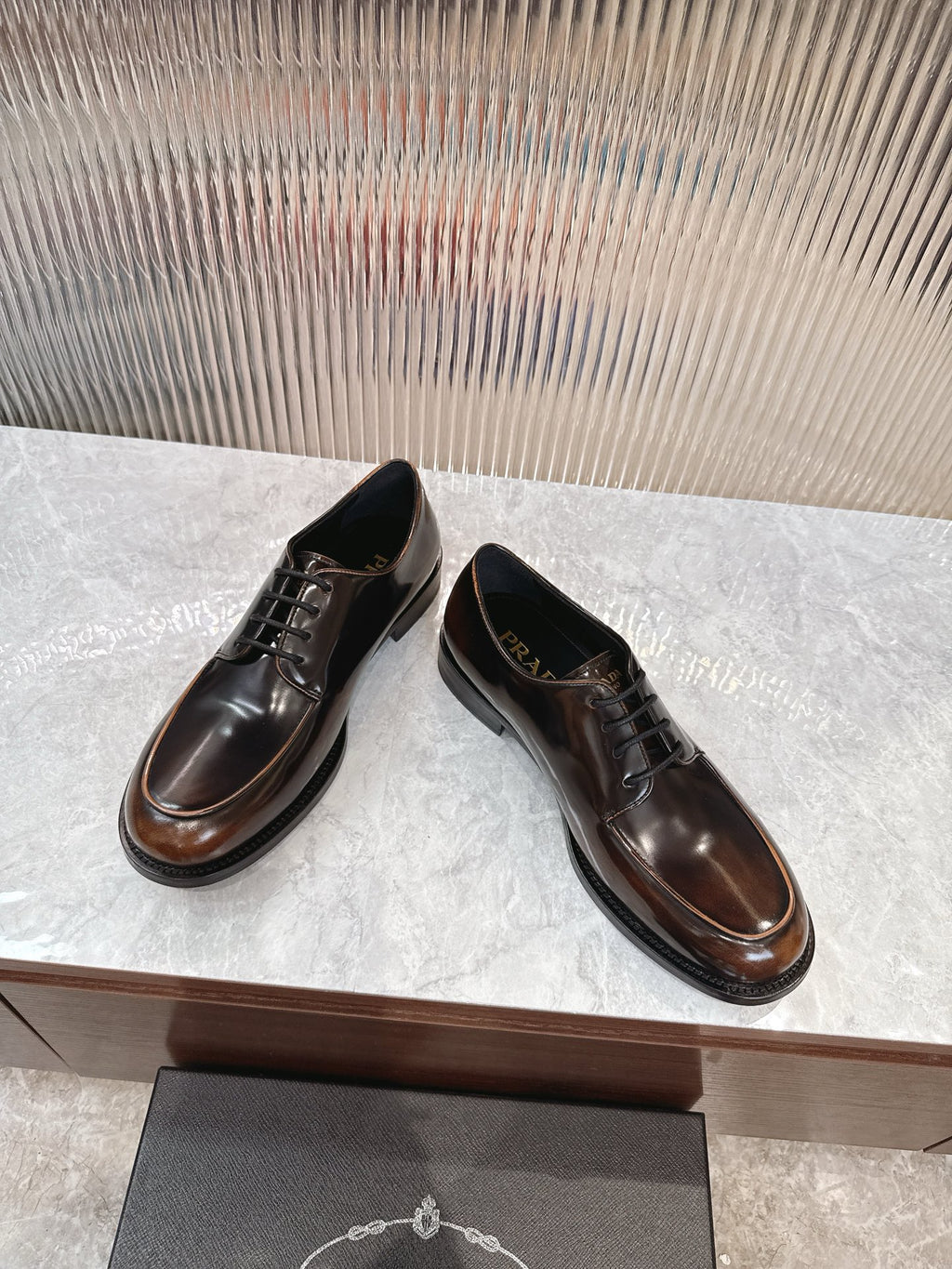 Lace-up leather shoes by Prada in dark brown, rounded toe and low stacked heel