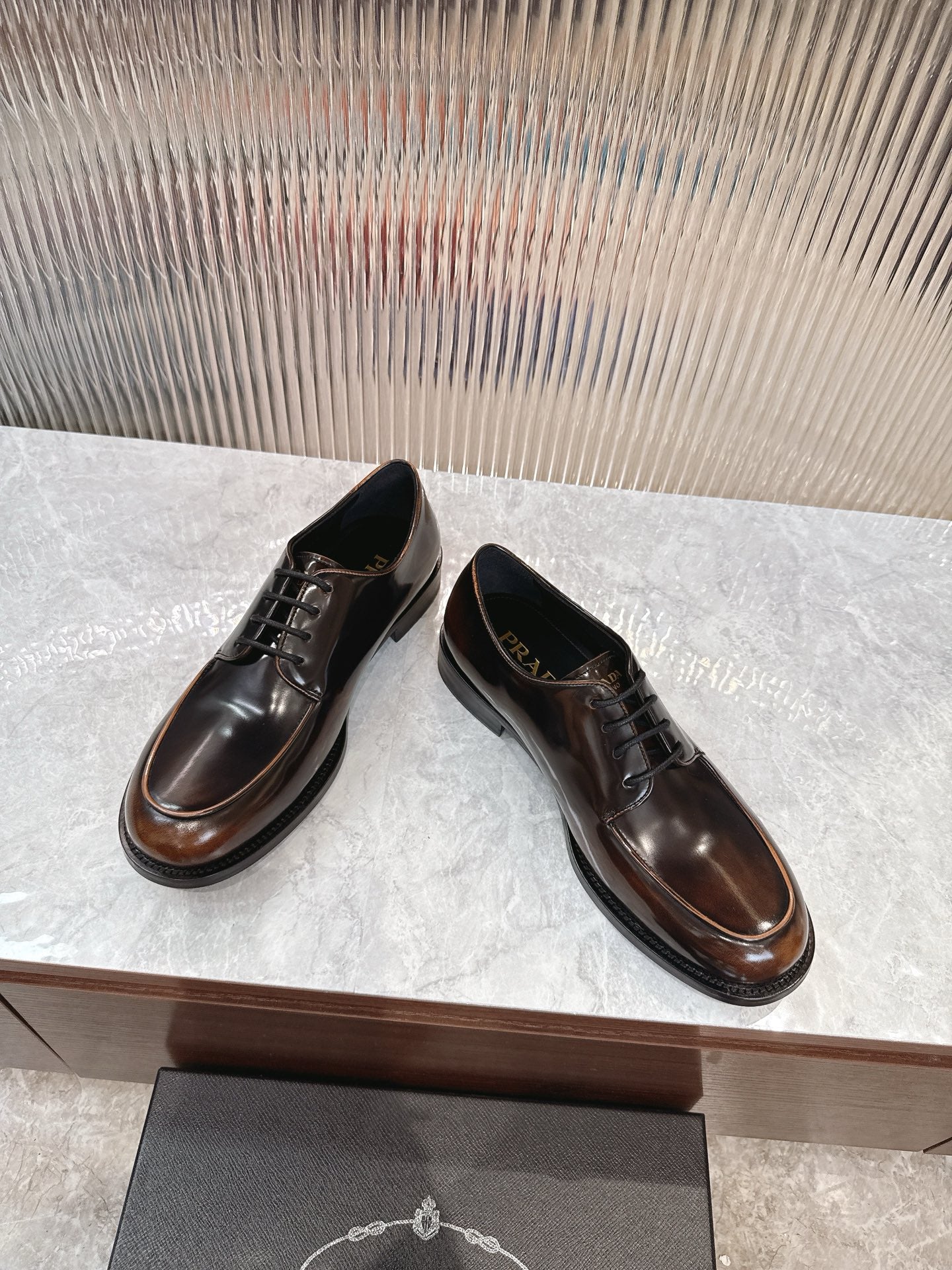 Lace-up leather shoes by Prada in dark brown, rounded toe and low stacked heel
