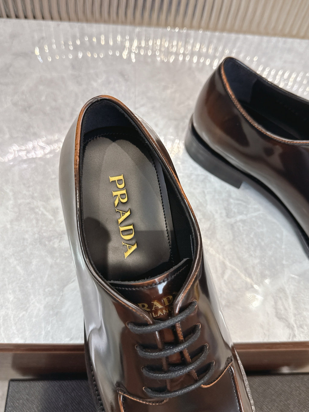 Prada lace-up leather shoe with PRADA logo on inner lining, dark brown upper