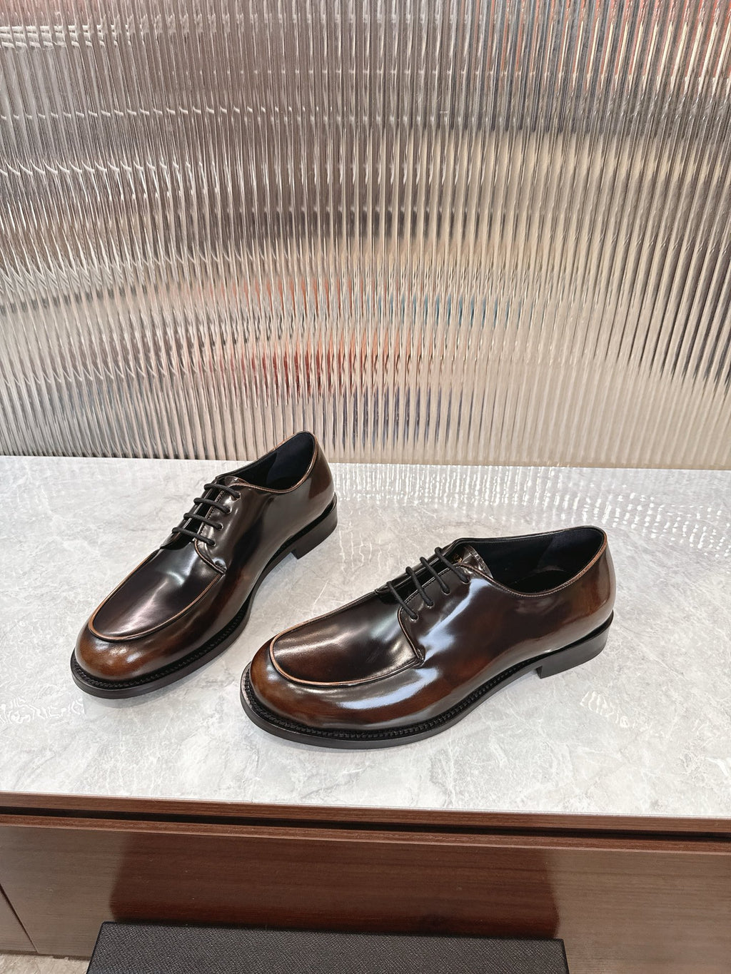Lace-up leather shoes by Prada, dark brown smooth upper with black lace-up front