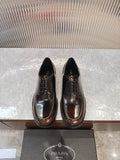 Lace-up leather shoes by Prada, dark brown with black laces and glossy finish
