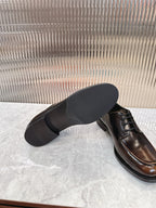 Lace-up leather shoes by Prada, dark brown upper with black sole and low profile heel