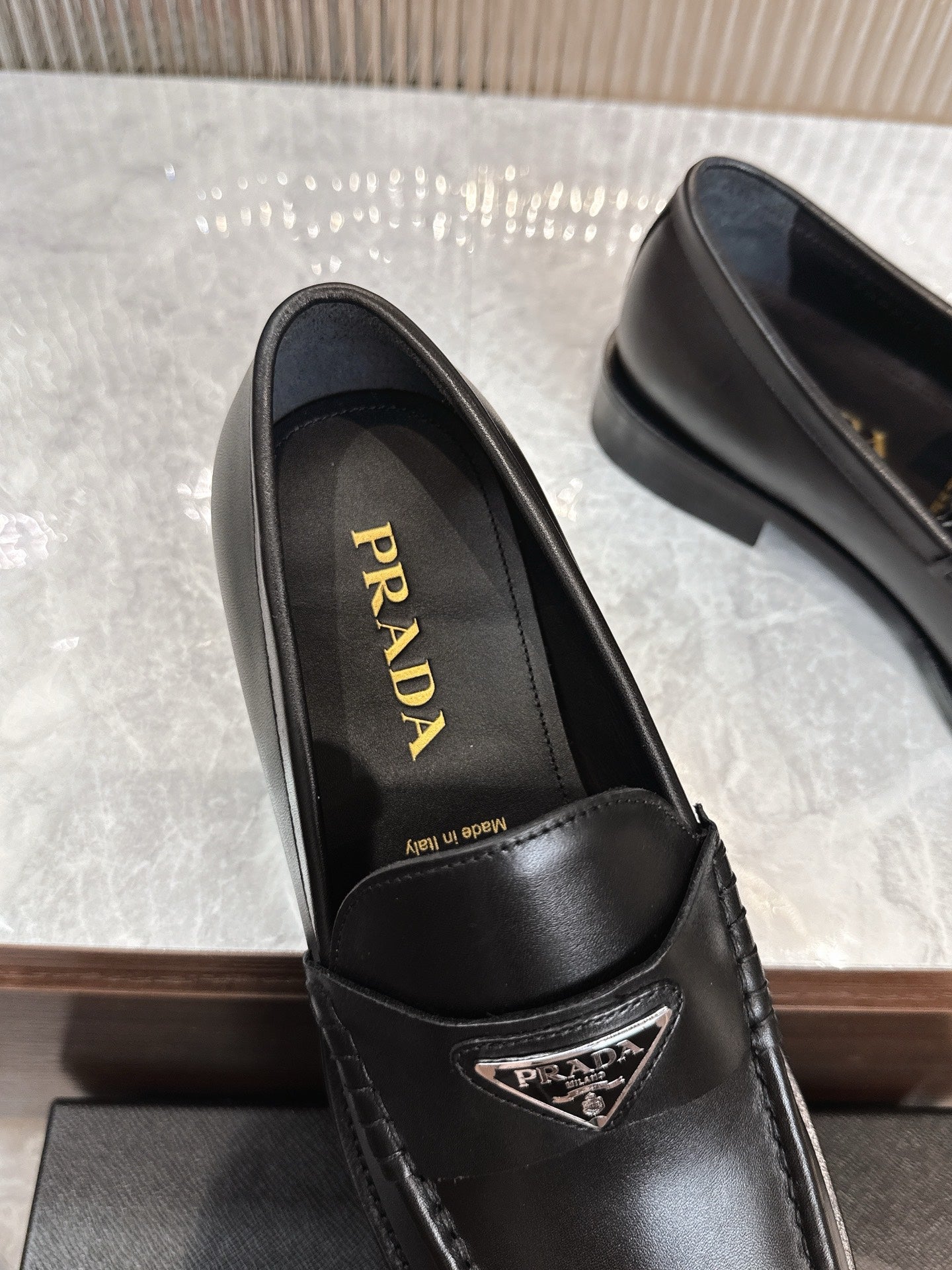 Prada unisex black leather loafer, interior view with Prada lettering on insole