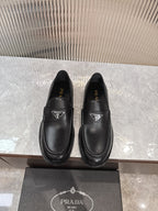 Prada unisex black leather loafers with triangular logo at the vamp