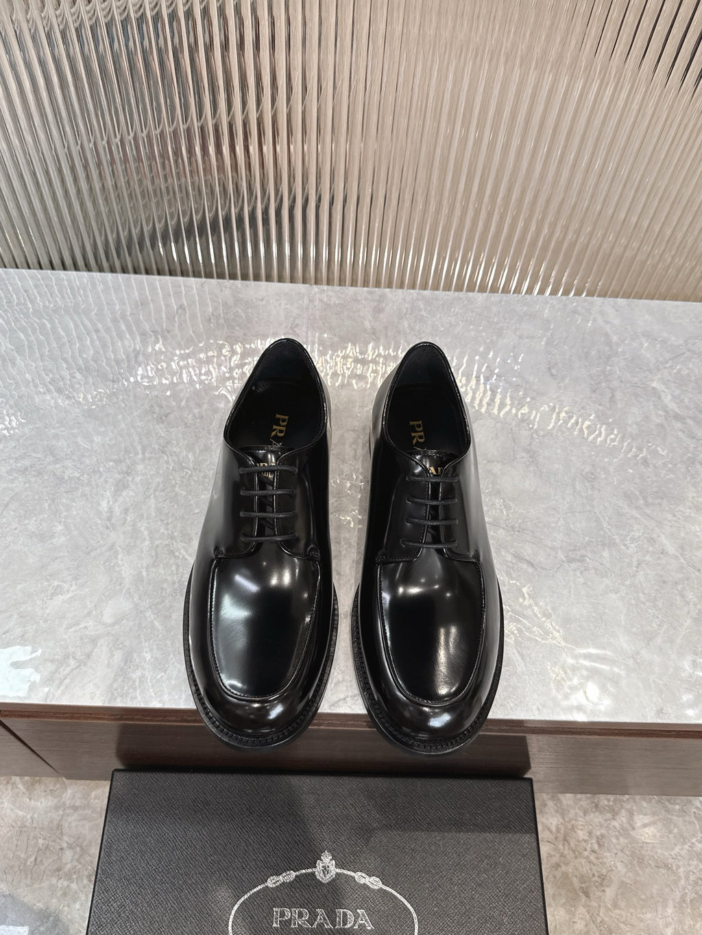 Prada unisex lace-up dress shoes, glossy black leather with rounded toe.