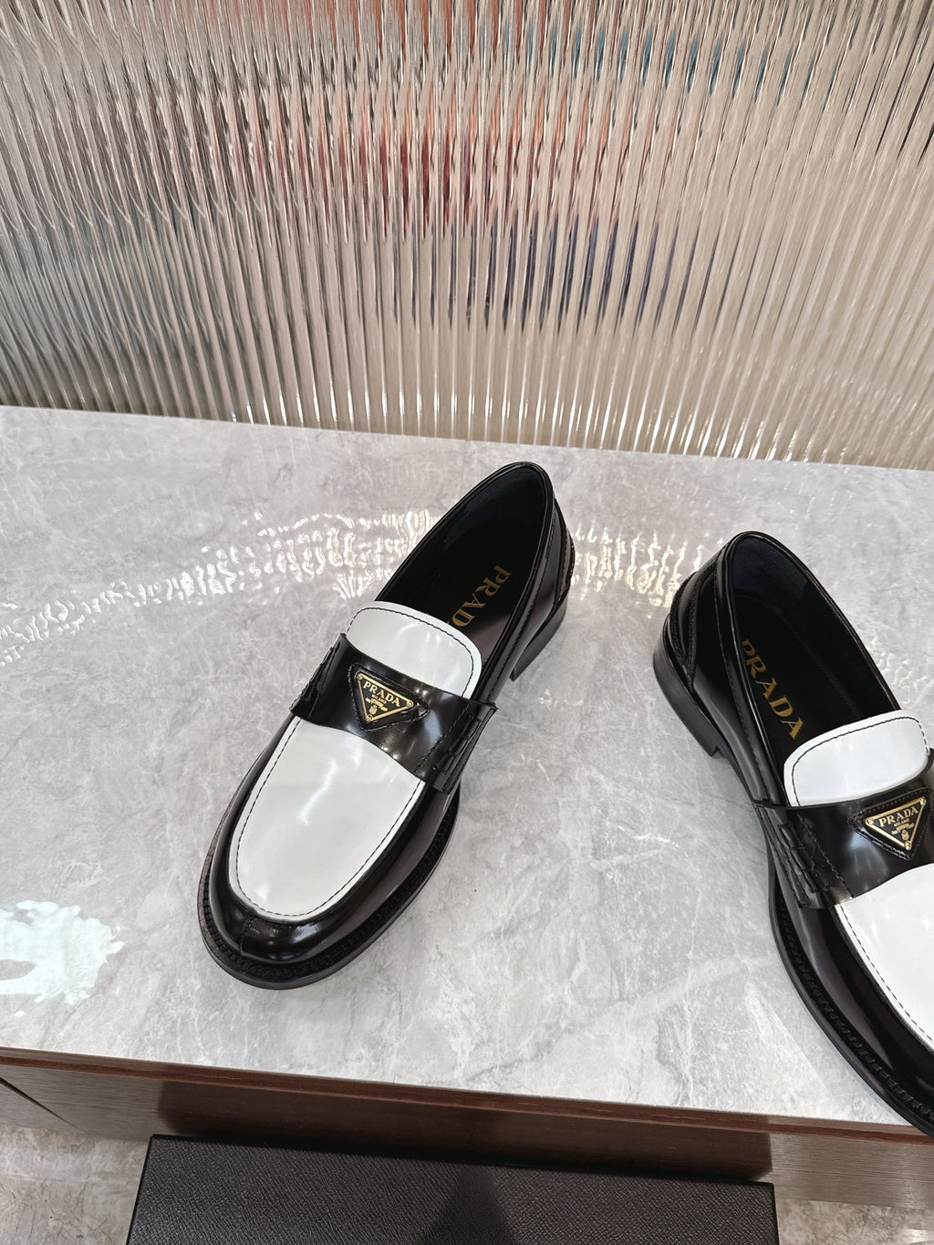 Prada unisex loafers, black upper with white band and gold triangle logo