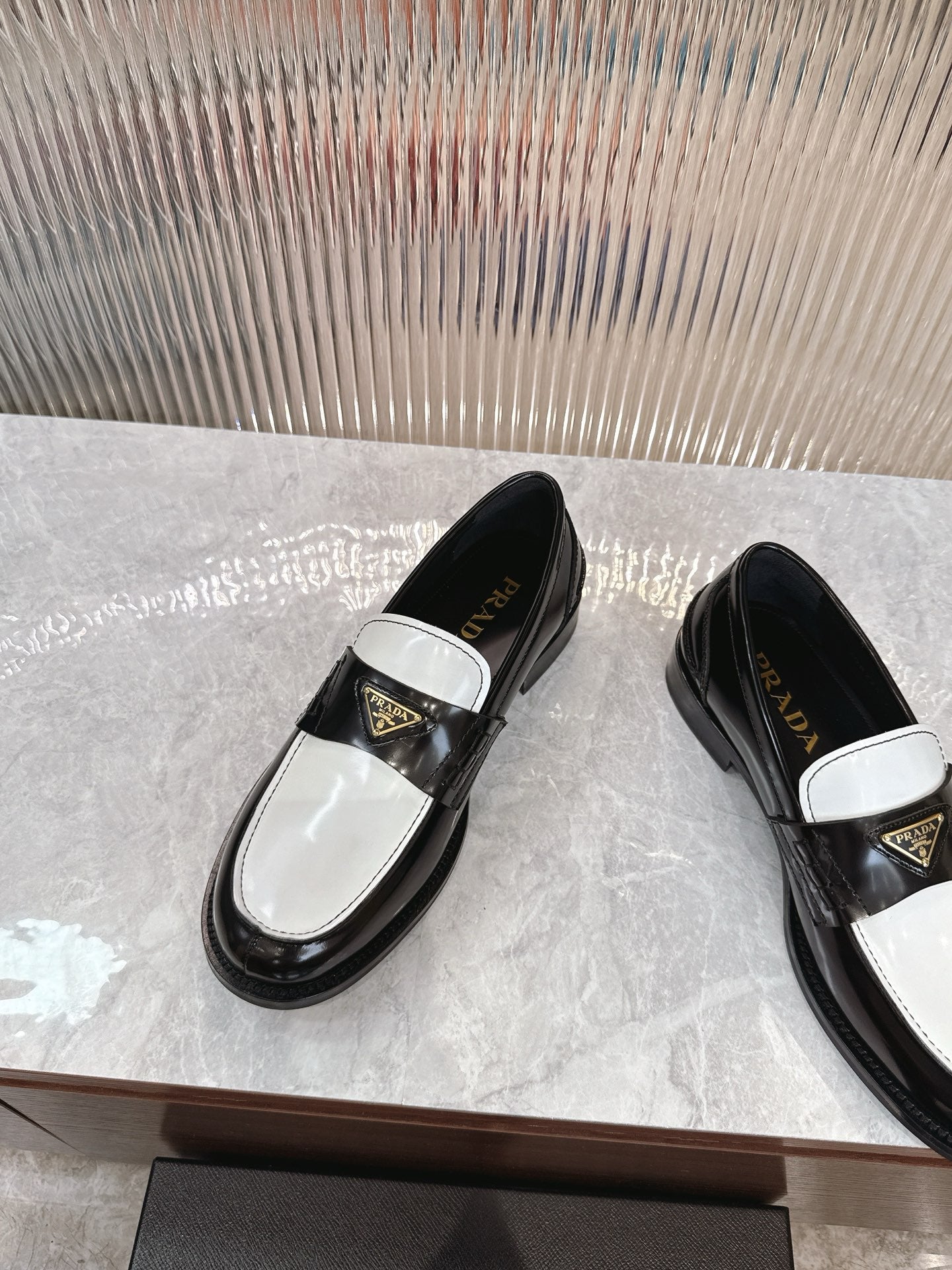 Prada unisex loafers, black upper with white band and gold triangle logo
