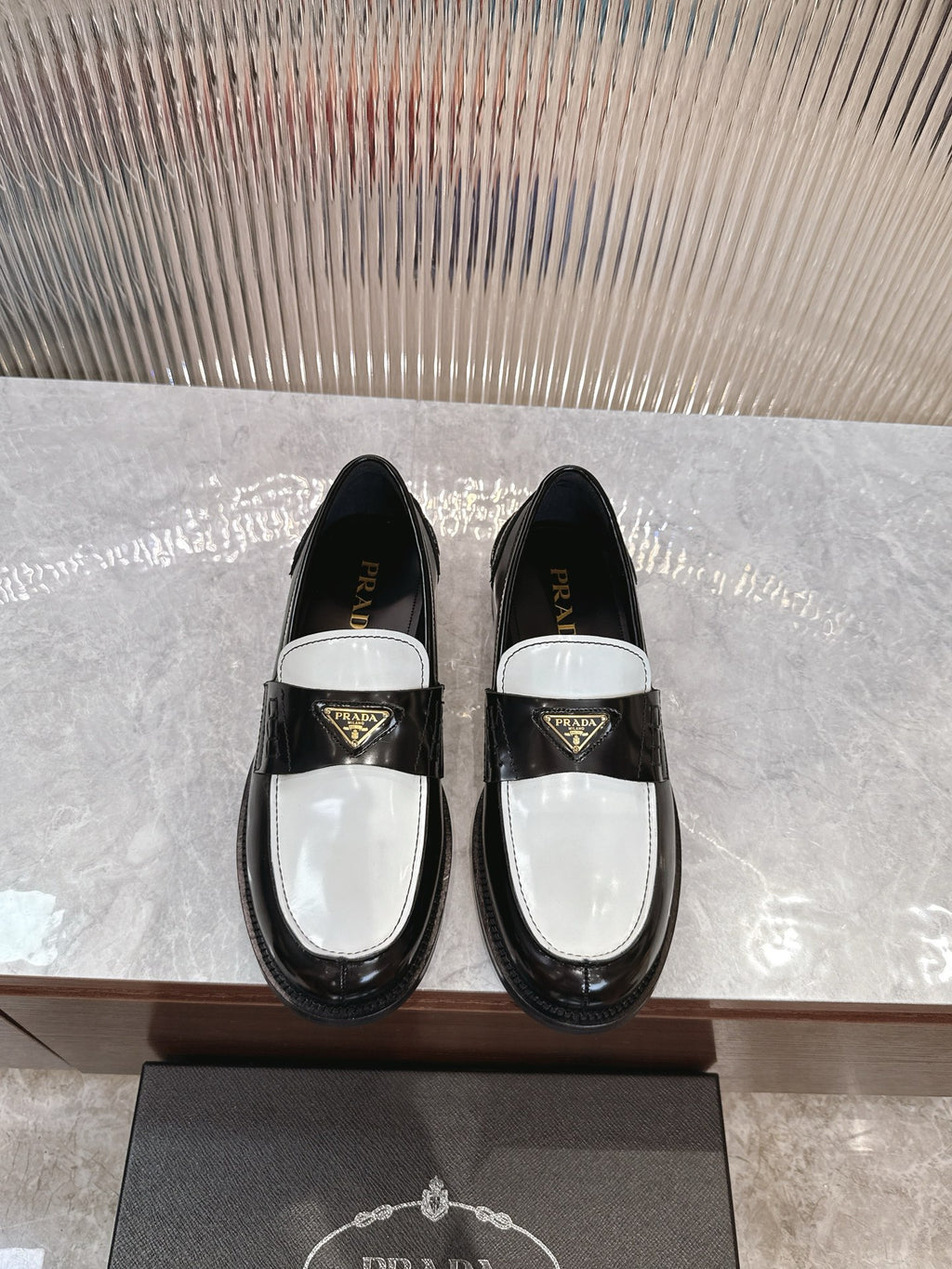 Prada unisex loafers, black leather with white saddle panel and gold logo