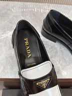 Prada unisex loafers, black leather interior with gold Prada logo on strap