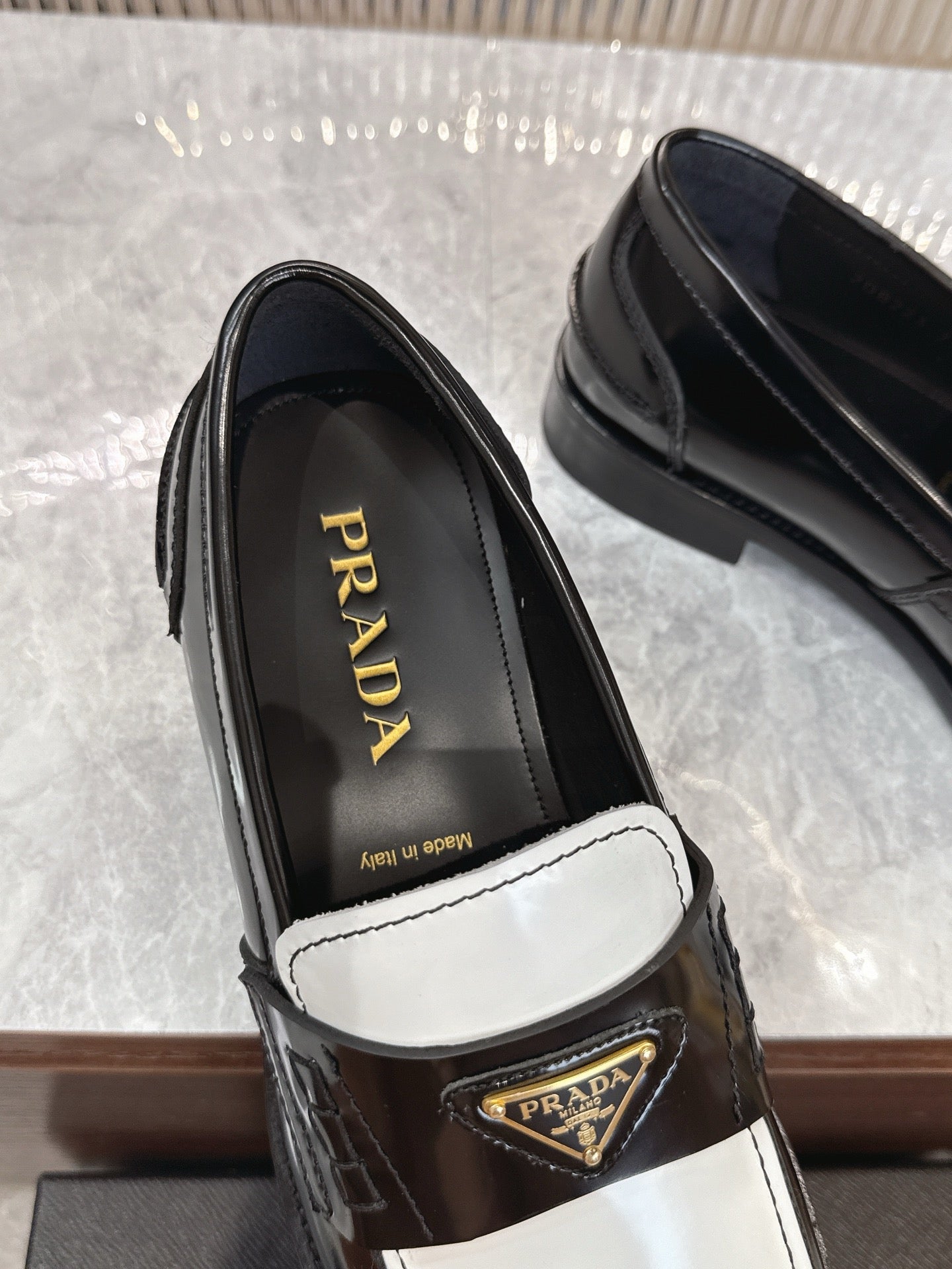 Prada unisex loafers, black leather interior with gold Prada logo on strap