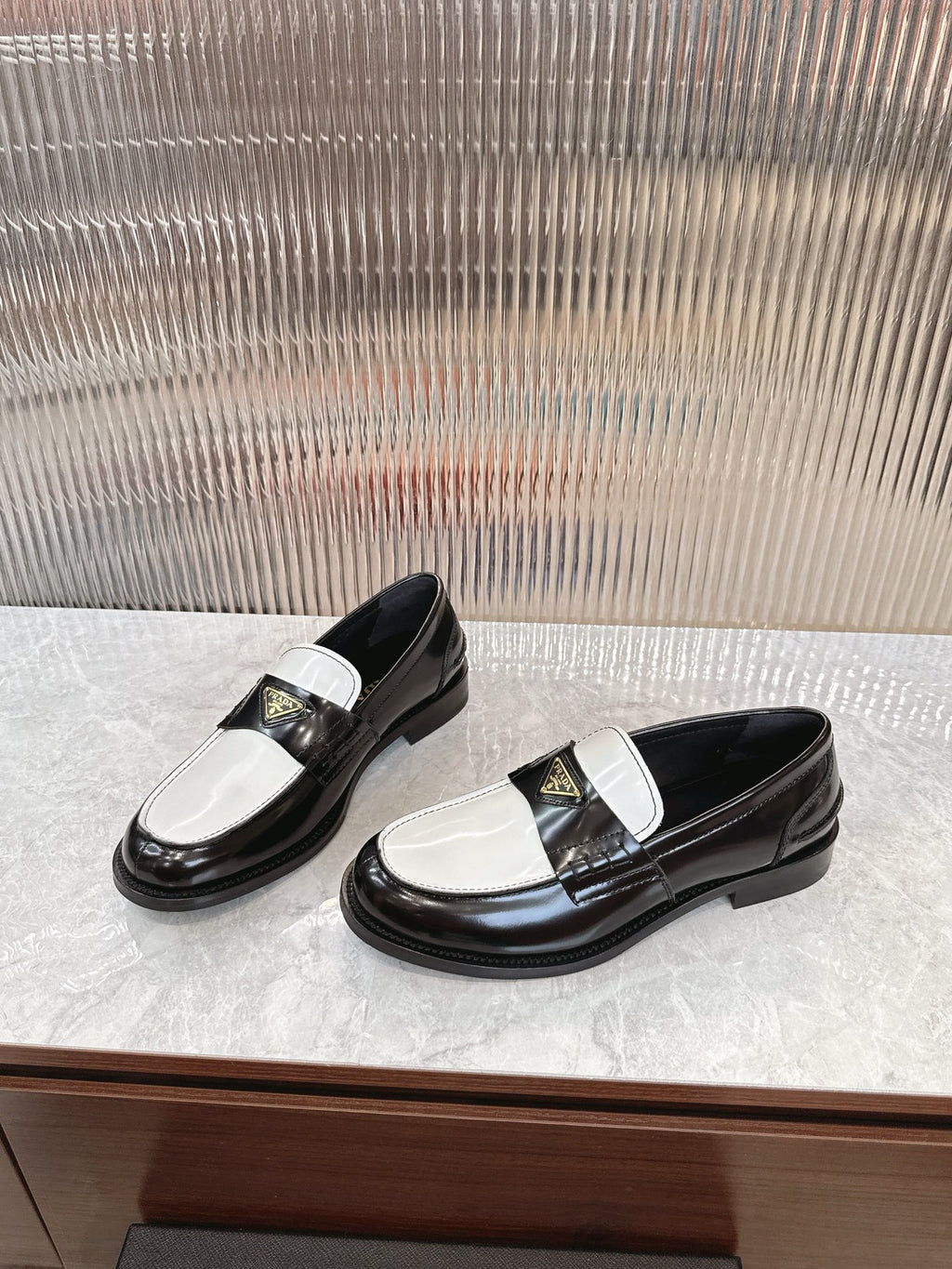 Prada unisex loafers, black-and-white leather with strap detail and low sole