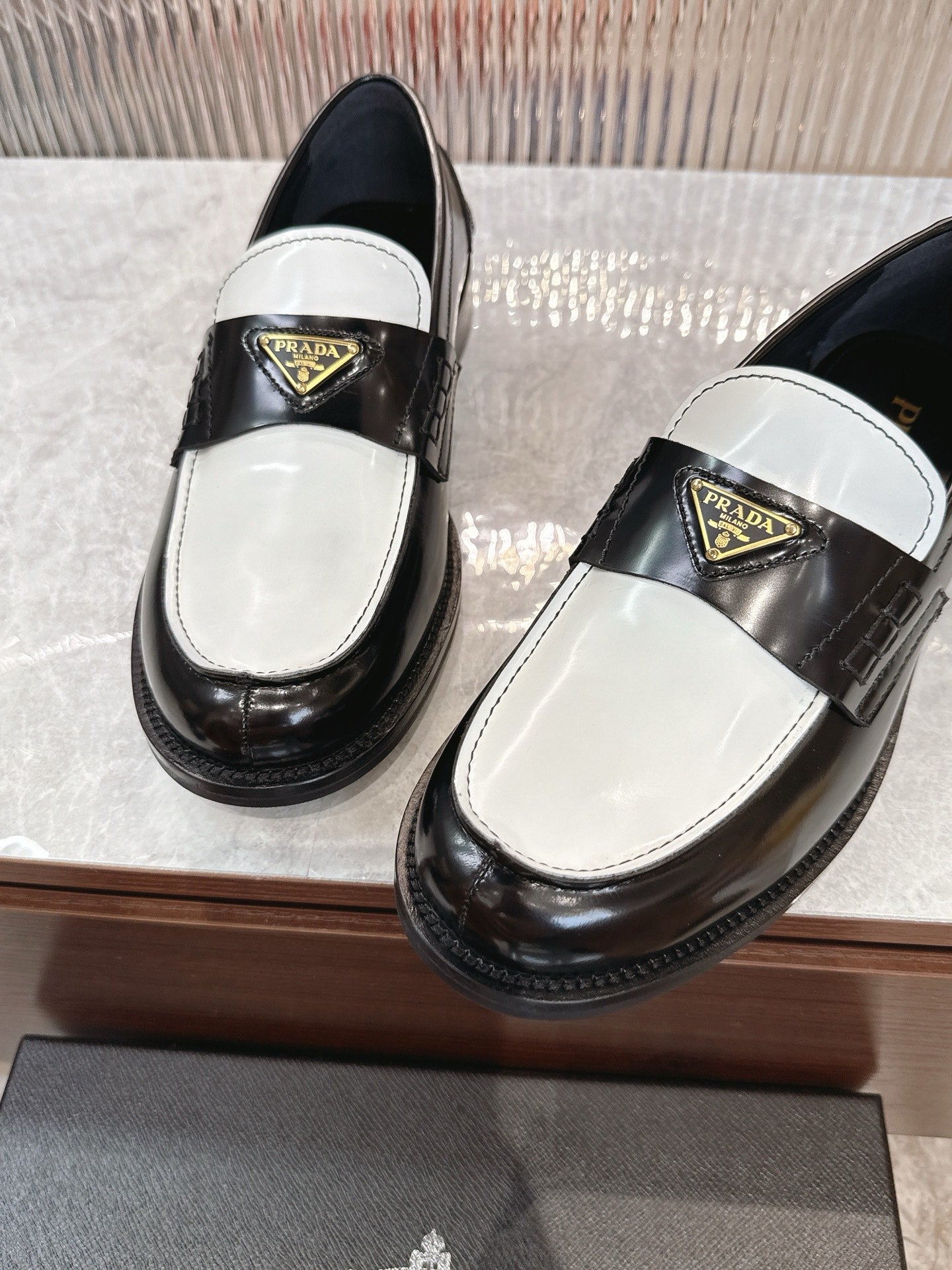 Prada unisex loafers, glossy black leather with white vamp and gold logo plaque