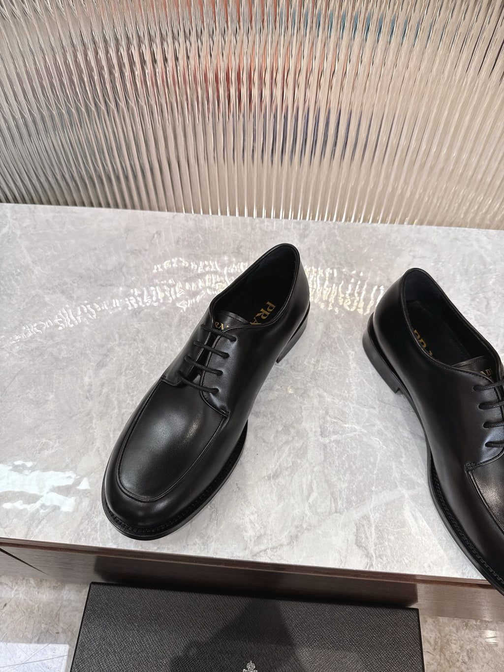 Black lace-up leather derby shoes with rounded toe and low sole