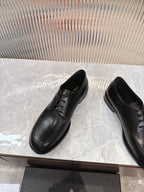 Black lace-up leather derby shoes with rounded toe and low sole