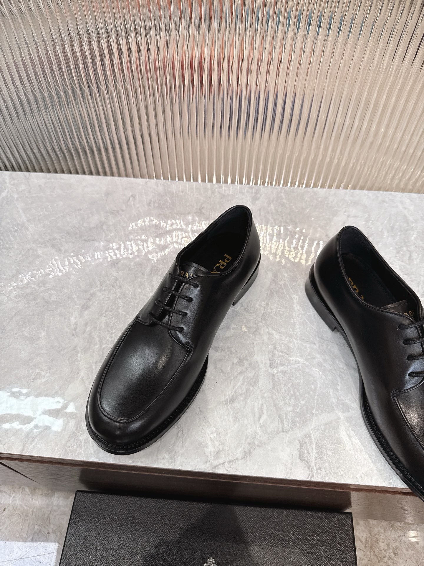 Black lace-up leather derby shoes with rounded toe and low sole