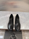 Black lace-up leather shoes with rounded toe and low profile sole