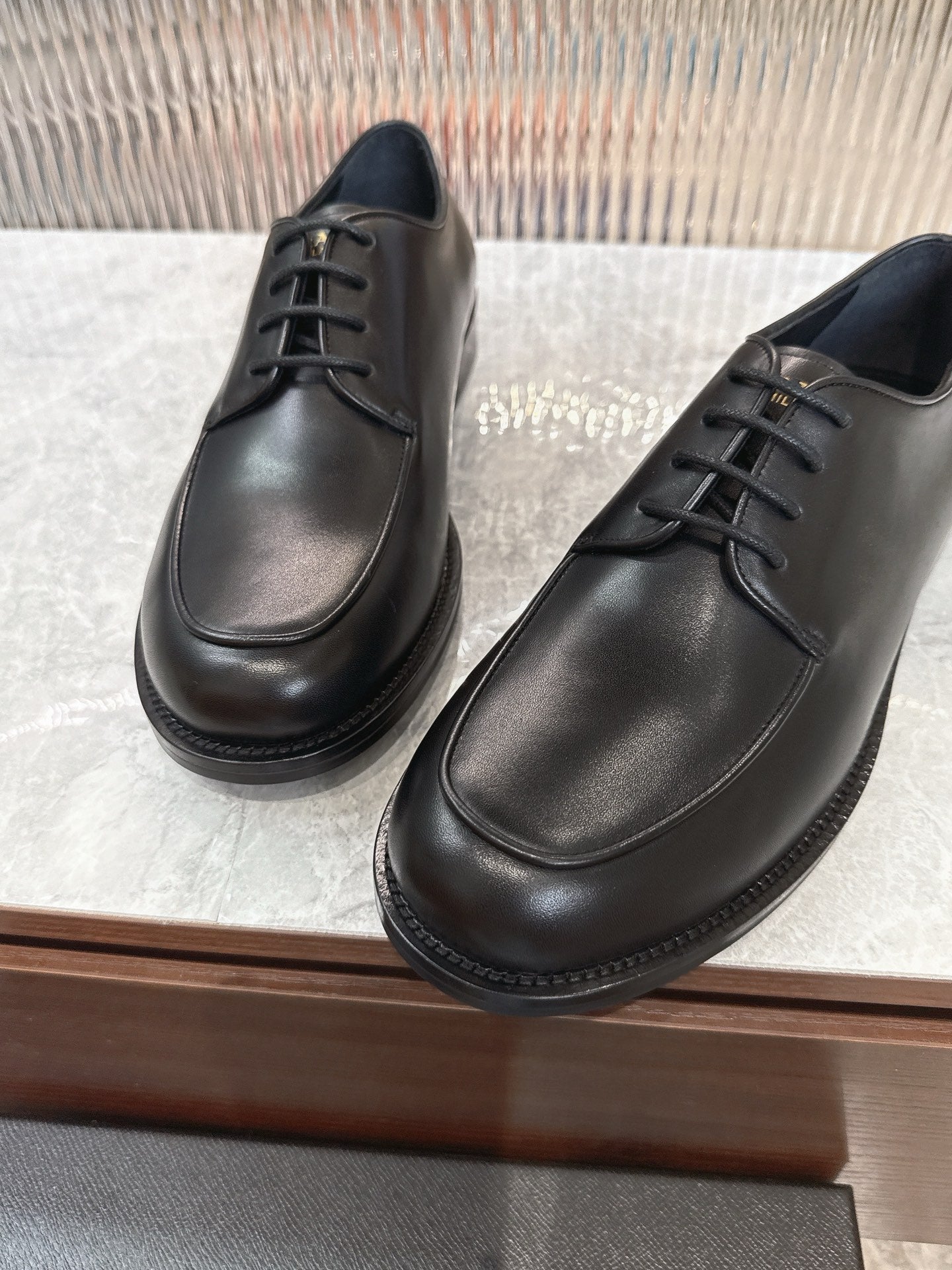 Black leather lace-up shoes with smooth upper and low rubber sole