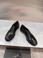 Black lace-up leather shoes, angled view, rounded toe and stitched upper