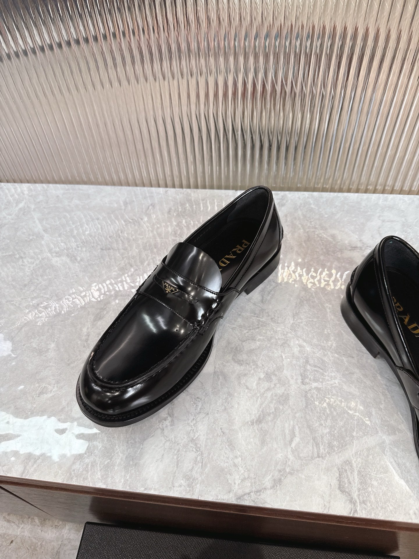 Prada unisex loafers, black leather with decorative strap and contrast stitching