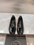 Prada unisex loafers, black leather with gold-toned hardware and stitched toe detail