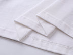 White T-shirt hem and side seam with stitched fold detail