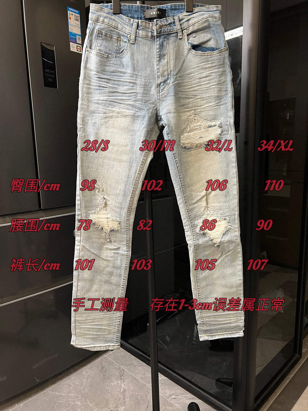 Light wash jeans with ripped knees and multiple distressed spots on the legs