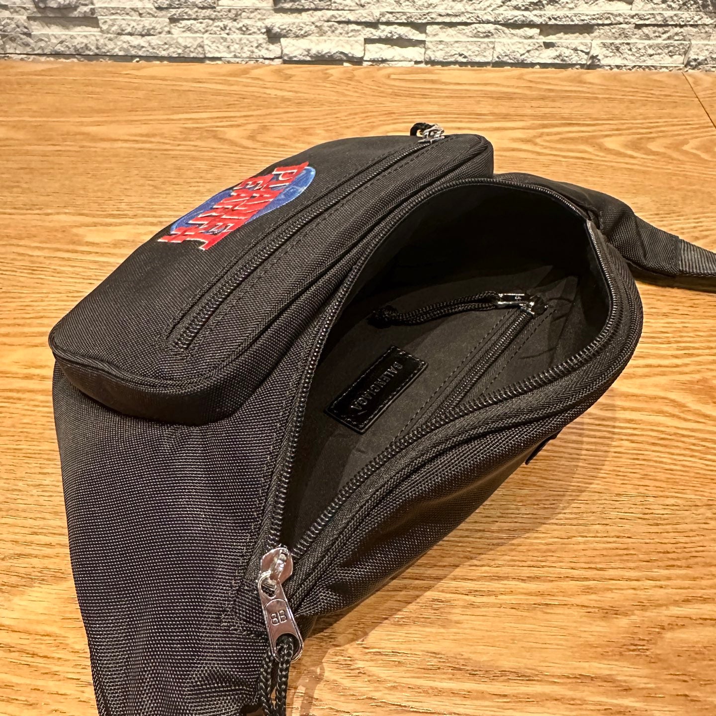 Balenciaga belt bag open view, showing inner compartment and zip pocket