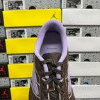 Brown leather sneaker tongue opening with Balenciaga label and purple lining.