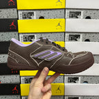 Brown leather sneakers with purple logo strip and lavender collar lining.