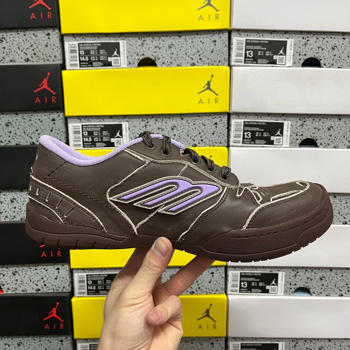 Brown leather sneakers with purple logo strip and lavender collar lining.