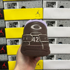 Brown leather sneaker heel with white 42 logo and stitched strap.