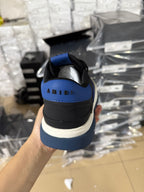 Low-top sneakers heel view with black upper, blue collar and white midsole