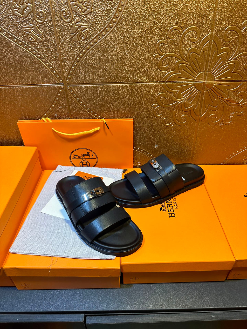 Hermes leather slide sandals pair, dark navy two wide straps and gold-tone buckle