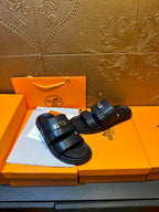 Hermes leather slide sandals pair, dark navy two wide straps and gold-tone buckle