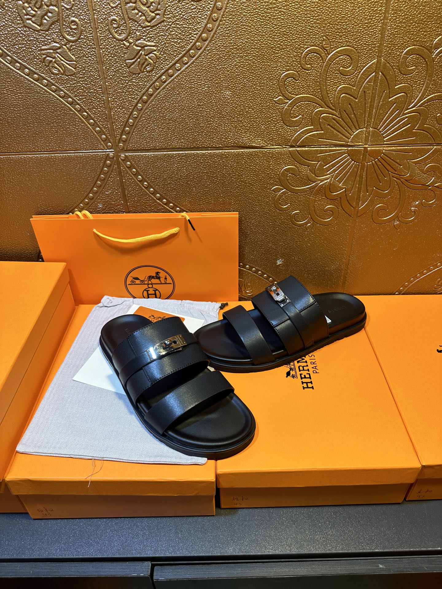 Hermes leather slide sandals pair, dark navy two wide straps and gold-tone buckle