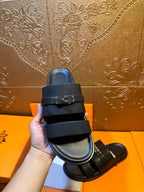 Hermes leather slide sandal upper close-up, dark navy double straps with metal buckle