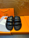 Hermes leather slide sandals with two dark navy straps and gold-tone buckle hardware