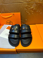 Hermes leather slide sandals with two dark navy straps and gold-tone buckle hardware