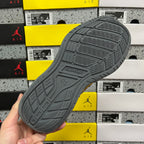 Grey rubber outsole with traction pattern and embossed logo on the heel.