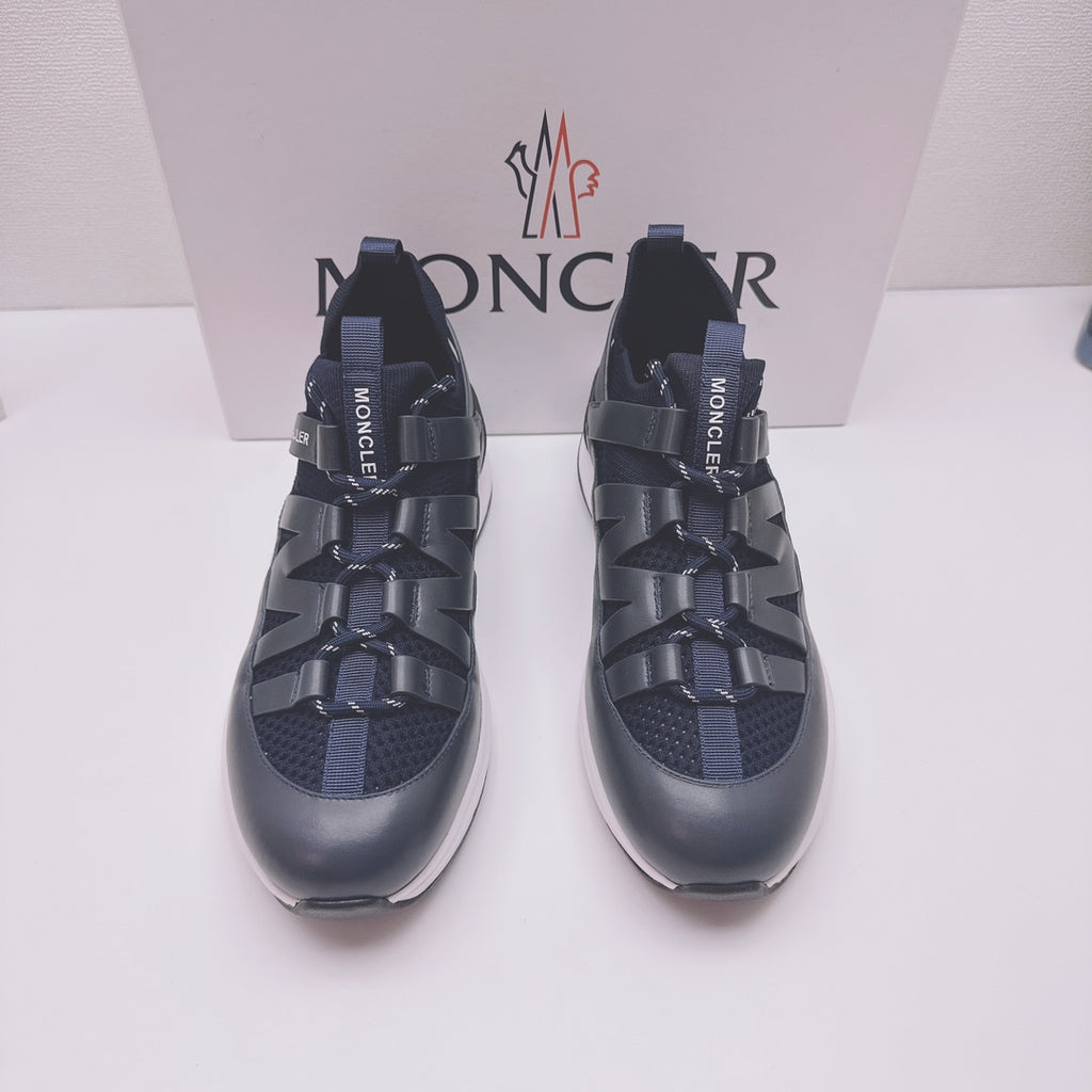 Moncler lace-up sneakers in dark blue with MONCLER logo on straps, front view