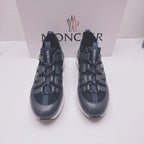 Moncler lace-up sneakers in dark blue with MONCLER logo on straps, front view