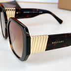 Bvlgari sunglasses close-up with black frame and gold ribbed temple