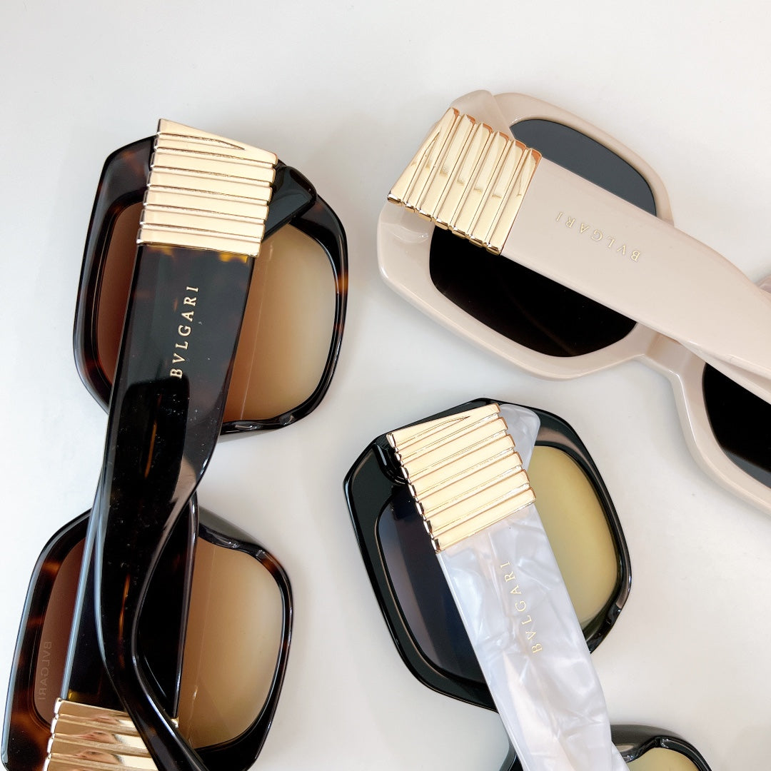 Bvlgari sunglasses with black and white frames, gold ribbed temples